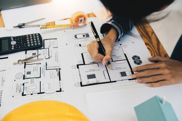 architect working in office with blueprints. Engineer inspect architectural plan, sketching a construction project