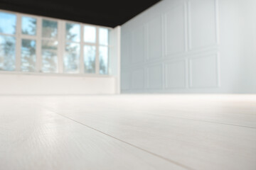 Fototapeta na wymiar Empty room with new white laminated flooring, closeup