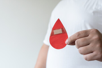 Concept of man with plaster giving blood donation to save patient life, medical emergency treatment