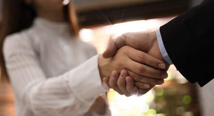Business partners shaking hands after meeting in office, closeup. Banner design