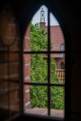The bell tower seen through a Gothic window.