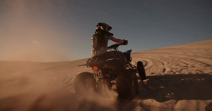 Rearview of a quad bike being driven uphill showing it's tyre tread  in Slow Motion