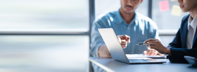 Pointing laptop, Meeting and consulting agenda of indian asia mixed race business man and female...