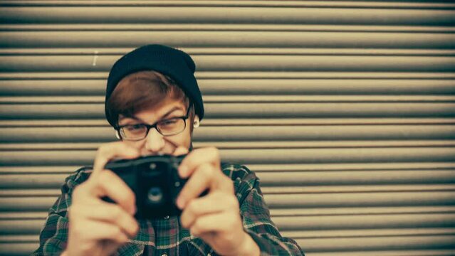 Hipster taking pictures with old vintage camera