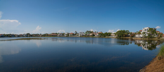 Single-family homes with Four Prong Lake views at Destin, Florida. Lakefront houses against the clear blue skyline at the background.