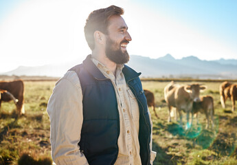 Sustainability, farming and man with cows on field, happy farmer in countryside with mountains,...