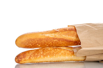 Two aromatic baguettes in a paper bag, macro isolated on white background.