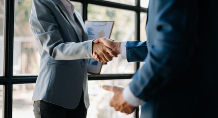 Two confident business man shaking hands during a meeting in the office, success, dealing, greeting...
