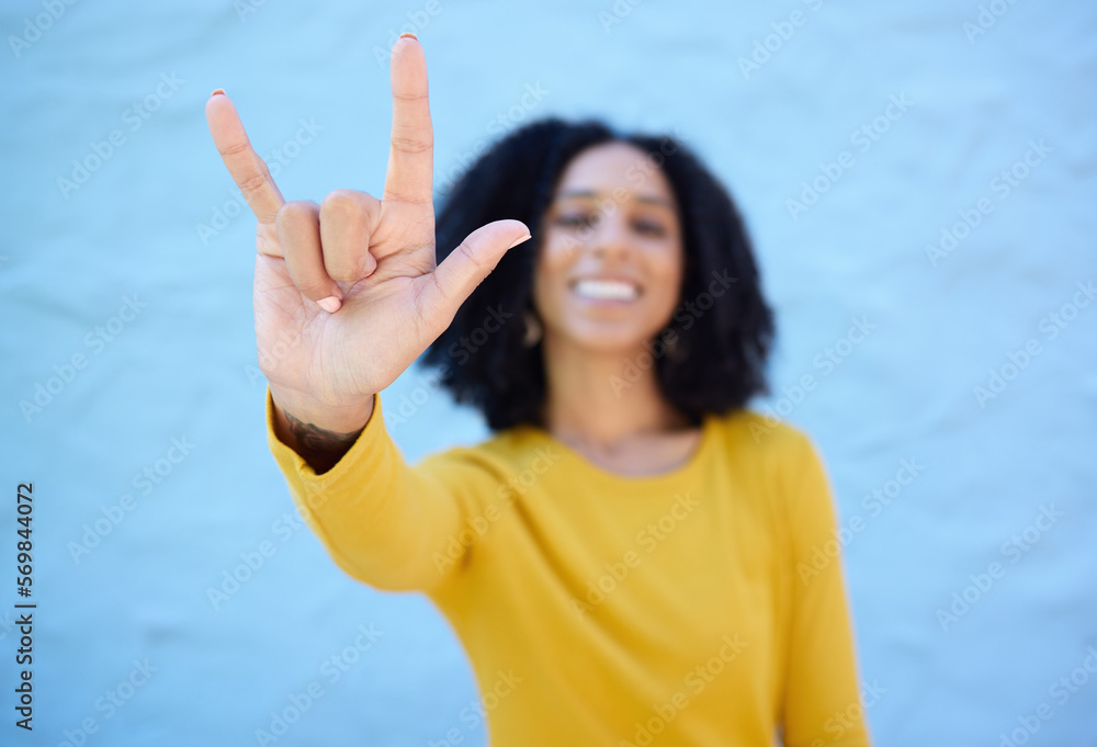 Sticker Rock sign, fashion and hands of black woman on blue background with smile, happy mindset and peace. Hand gesture, beauty and face of African girl relax with urban style, trendy and stylish clothes