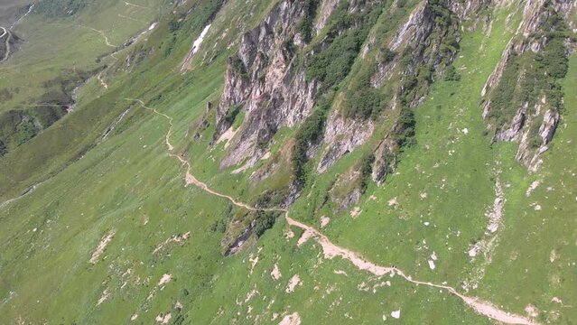 Aerial view of a trail winding through the Swiss mountains