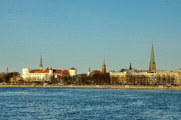 Fototapeta na wymiar riga, panorama of the city, in the background the blue sky in the foreground is the river