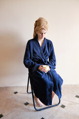 young millennials woman in bathrobe takes cosmetic procedure