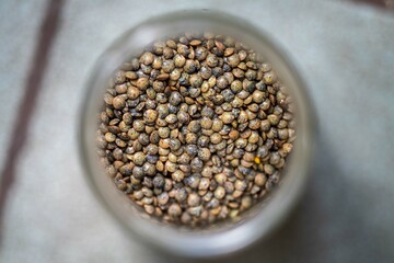 dried fruit, dates, prunes, grains, wheat, lentils, rice stored in glass jars in a kitchen