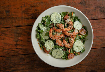 Shrimp Salad with Greens on a Wooden Table