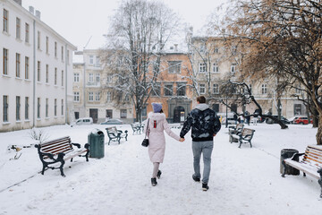 couple in love is walking through a snowy winter town