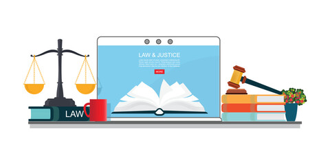 Law books with a judge s gavel and scales on laptop.