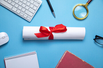 Diploma and business objects on the blue background.