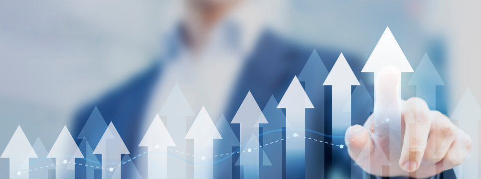 Business growth with businessman touching chart with arrows pointing up. Growing revenue and profit. Successful plan or strategy, good sale performance or return on investment.