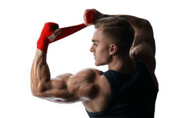 Muscular man is wrapping hands with red boxing wraps