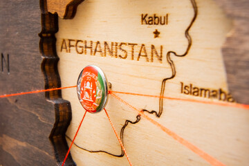 Afghanistan flag pins and red thread for traveling and planning trips. Planning of logistics routes...