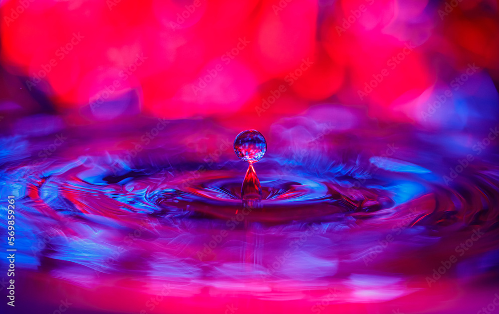 Aufkleber a transparent drop with a red-violet background falls into the water. abstract colorful background.