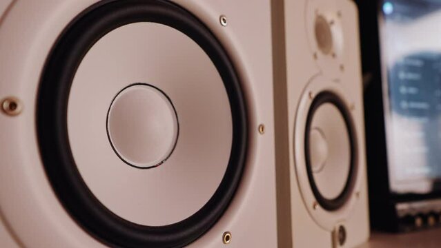 Professional white studio monitors vibrating, playing music. High quality 4k footage