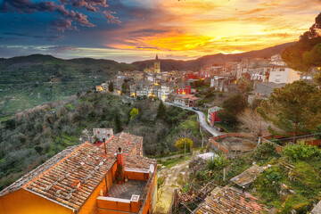 Amazing Panorama of the belltower and the village in the valley at early sunrise.