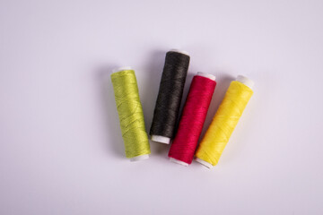 Spools with colored thread on a white background