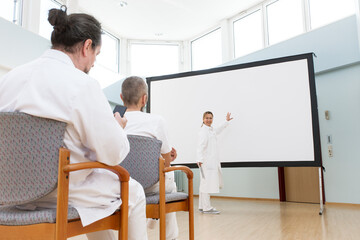 doctor seminar, doctor shows something on whiteboard