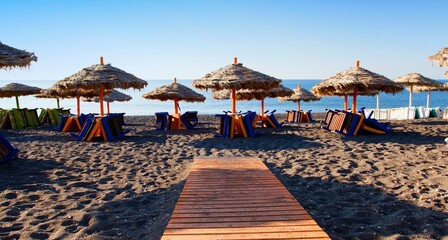 Black beach in the resort of Perissa on the island of Santorini in the Aegean Sea in the South Cyclades archipelago of Greece.
