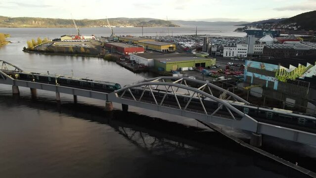 Trains crossing each other on the bridge over the river Drammenselva near the harbor in Drammen, Norway