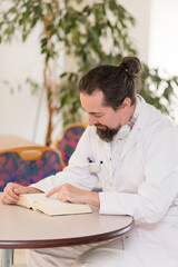 doctor in a hospital reads a book during lunch break