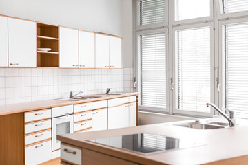 an empty kitchen with windows