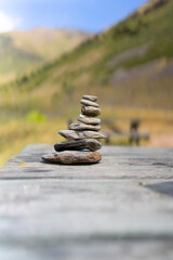 Cairn with rocks in a wood table. Mountain