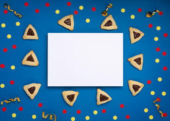 Hamantaschen Cookies, Carnival Mask, Noisemaker on Blue Background. Purim Celebration, Jewish Carnival Holiday Concept.