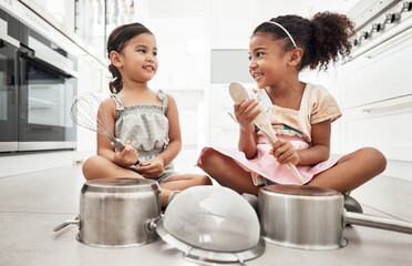 Girl kids playing house with pots as drums, happy and care free at family home, make believe with...