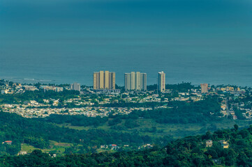 Obraz premium A view towards the coast from the tropical rainforest in Puerto Rico on a bright sunny day