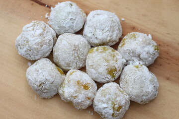 a close up of durian-flavored mochi served on a cutting board and ready to be eaten.