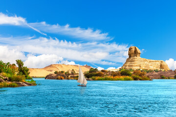 Lonely sailboat in the Nile on the way to the Great Sphinx, Aswan landscape, Egypt