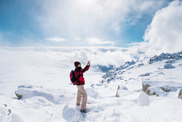 Fototapeta na wymiar Woman Taking Pictures in the High Snowy Winter Mountain .Vitosha Mountain ,Bulgaria 