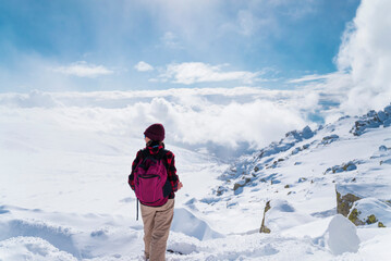 Fototapeta na wymiar Woman Hiking in the High Snowy Winter Mountain .Vitosha Mountain ,Bulgaria 