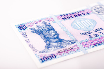 Obraz premium Moldovan leu. Banknote of one thousand Moldovan lei. Close-up of a banknote with many small details. With the image of Stefan cel Mare. Macro shooting. Photographed on a white background.