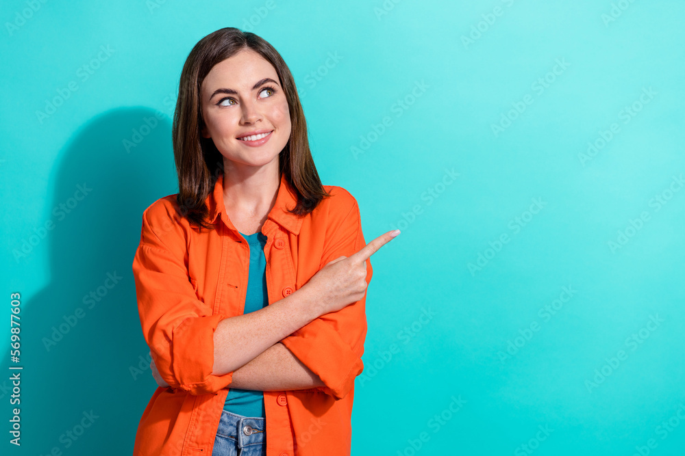 Poster photo of positive cute lady wear trendy orange clothes arm presenting empty space interesting news i