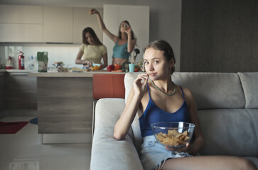 group of girls in the kitchen preparing dinner