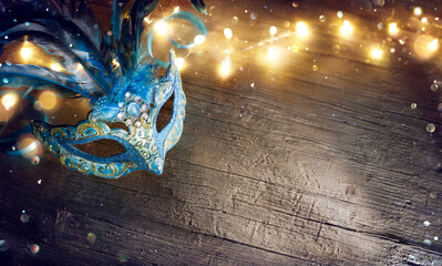 Venetian Mask On Wooden Table With Defocused Bokeh Lights In Dark © Romolo Tavani
