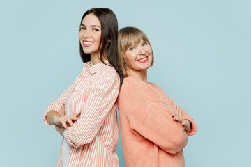 Side view elder parent mom with young adult daughter two women together wearing casual clothes hold...