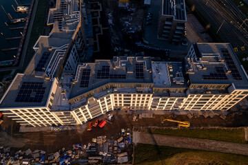 Top down aerial view of luxury Kade Zuid apartment complex construction at sunset at riverbank of river IJssel part of countenance cityscape of tower town Zutphen. 