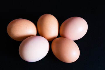 Five colored eggs on a black background