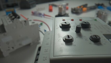 Phase control relay and relay with electromagnetic coils on the table. Close up of equipment with...