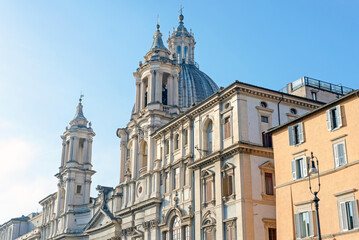 Church and buildings in sunny Rome. Architecture, windows, roofs.